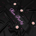 Black hen party sash with pink writing displayed on black satin with pink roses and confetti