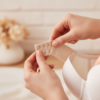 Woman attaching nude cream bra extension strap with silver hooks to bra band - lifestyle photo