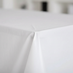 Extreme close-up macro shot of white plastic tablecloth surface showing smooth glossy material quality and drape