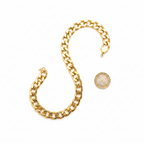 Chunky gold chain necklace 68cm beside a £1 coin on white background showing product size — flat lay