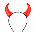 Red devil horns on a black headband against a white background.