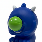 Extreme macro close up of cobalt blue Google Eyed Squeeze Monster showing soft rubber texture and detail