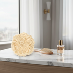 613 Daisy platinum blonde curly messy hair bun on marble vanity with hairbrush and perfume, natural window light lifestyle shot