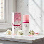 Taylor of London White Satin EDT on white marble vanity with fresh white flowers and pink petals