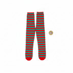 Flat lay of womens red and green striped tights beside a pound coin for scale reference on white background