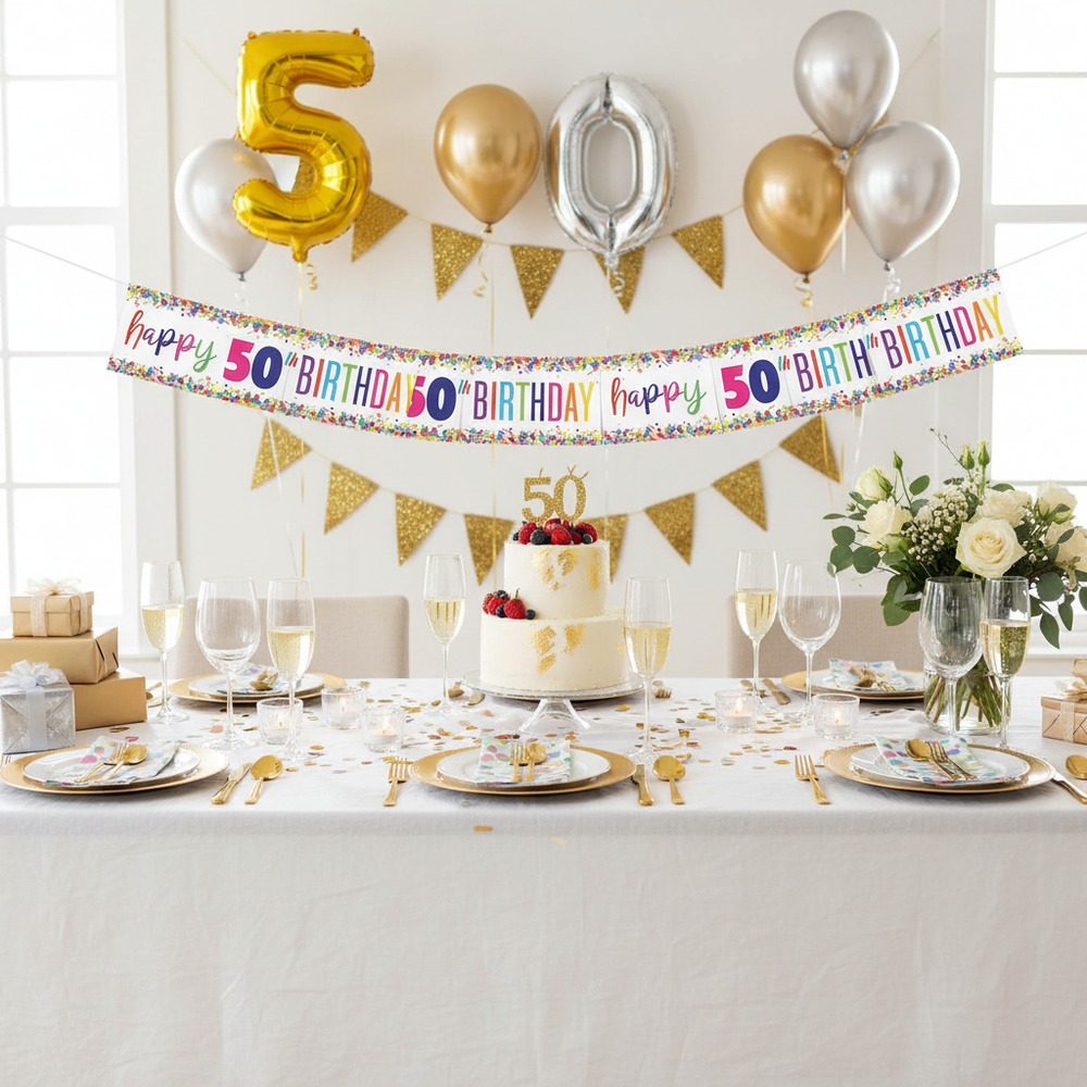 Elegant 50th birthday party table setting with multi-coloured foil banner displayed above