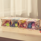 Squishy squeeze toys in lime green, pink, lavender and sky blue arranged inside colourful children's party bags