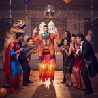 Group of friends laughing at person in Inflatable Rocket Man costume — star of the fancy dress party