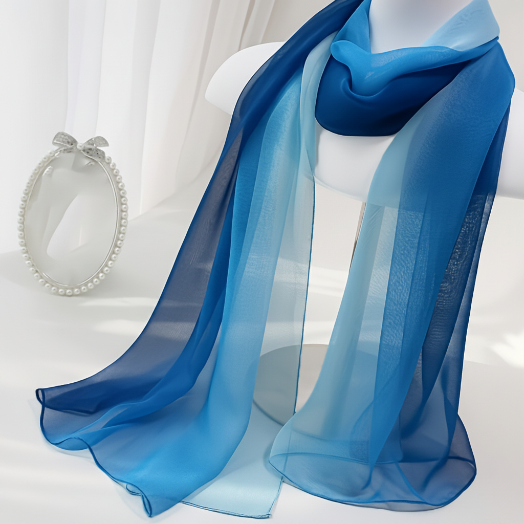 Close-up detail of navy blue to sky blue gradient chiffon scarf showing sheer fabric texture and colour transition