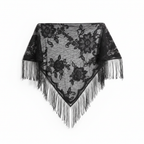 Black sheer lace triangle shawl with floral embroidery and long tassel fringe elegantly draped on white background, studio product shot