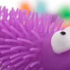 Extreme macro close-up of the purple puffer spines and rubber texture of the Big Eye Puffer Caterpillar squeeze toy
