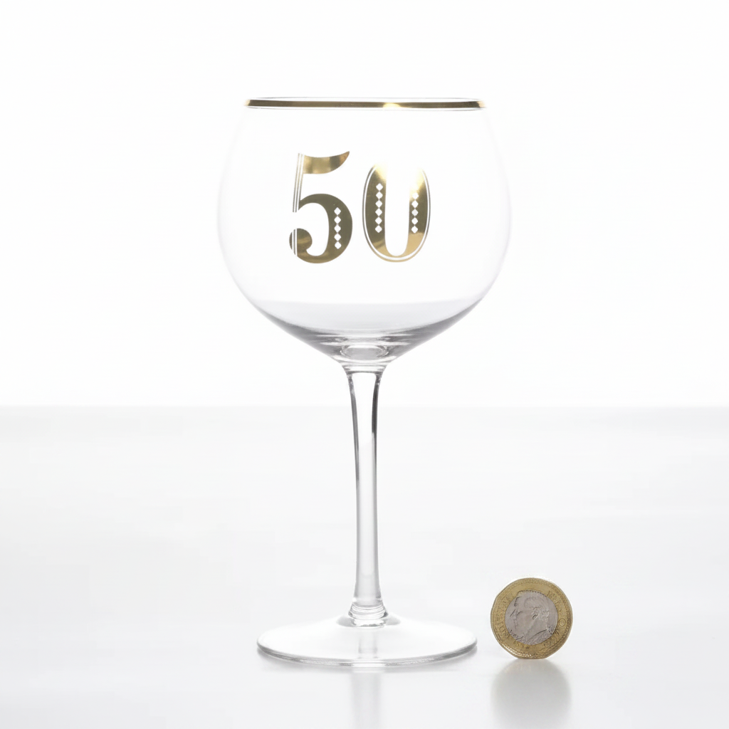 Art Deco 50th Birthday Gin Glass flat lay beside a £1 coin on white background to show product scale