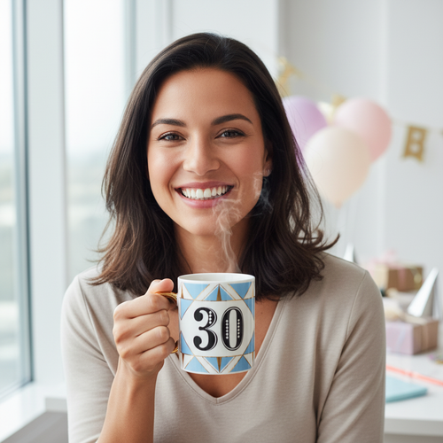 Happy person celebrating 30th birthday holding Art Deco white blue gold mug at birthday party