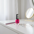 W7 Fluorescent Pink Nail Polish 15ml on vanity with nail file and accessories, natural window light editorial beauty styling