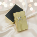 Gold metallic gift box with silver bow on elegant background - premium jewellery packaging 3x2 inches