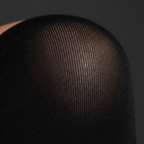 Extreme macro close-up of black thigh high stocking fabric showing fine knit texture and material quality