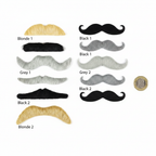 Flat lay of all 6 fancy dress moustaches in blonde, black and grey beside a British £1 coin for scale on white background