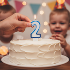 Hands placing Blue Number 2 Birthday Candle onto a white frosted celebration cake - Why Not Shop