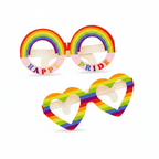 Two pairs of Gay Pride cardboard novelty glasses on pure white studio background — round rainbow HAPPY PRIDE frames and heart-shaped rainbow striped frames