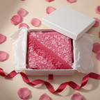 Rose red triangle lace scarf elegantly presented in a white gift box with tissue paper, ribbon and rose petals