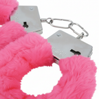 Close up of soft pink fur and silver metal clasp on hen party handcuffs