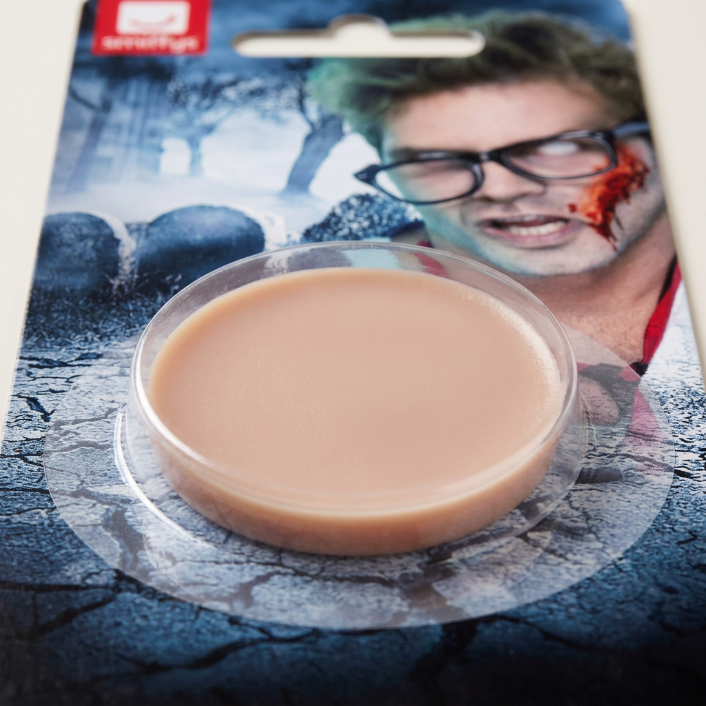 Close-up of the flesh-toned fake skin makeup pan in its clear blister on the Smiffys Special FX card