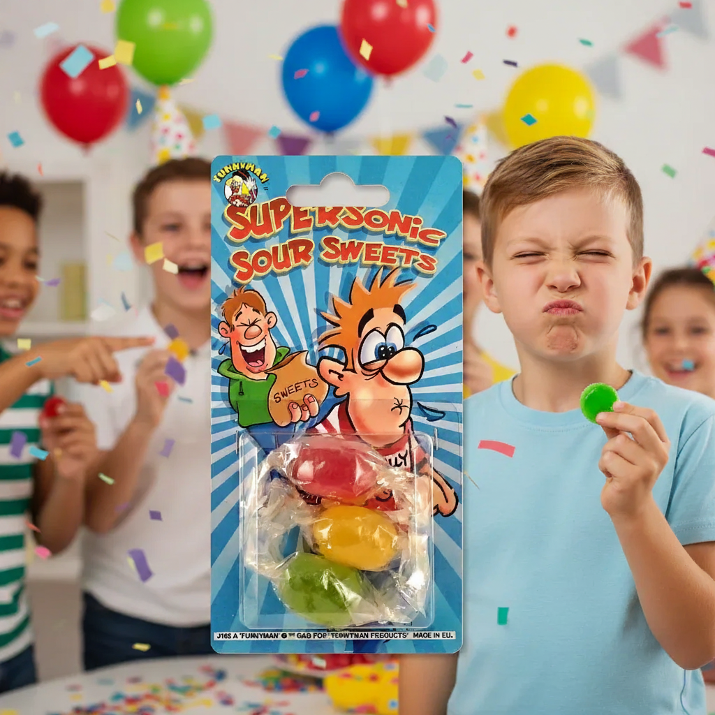 Boy pulling exaggerated sour face holding Funnyman Supersonic Sour Sweets packaging at birthday party with friends laughing