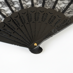Black wooden handle and gold pivot pin detail of black lace hand fan