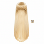 Flat lay of womens long straight golden blonde fringe wig on white background beside a pound coin to show scale and length