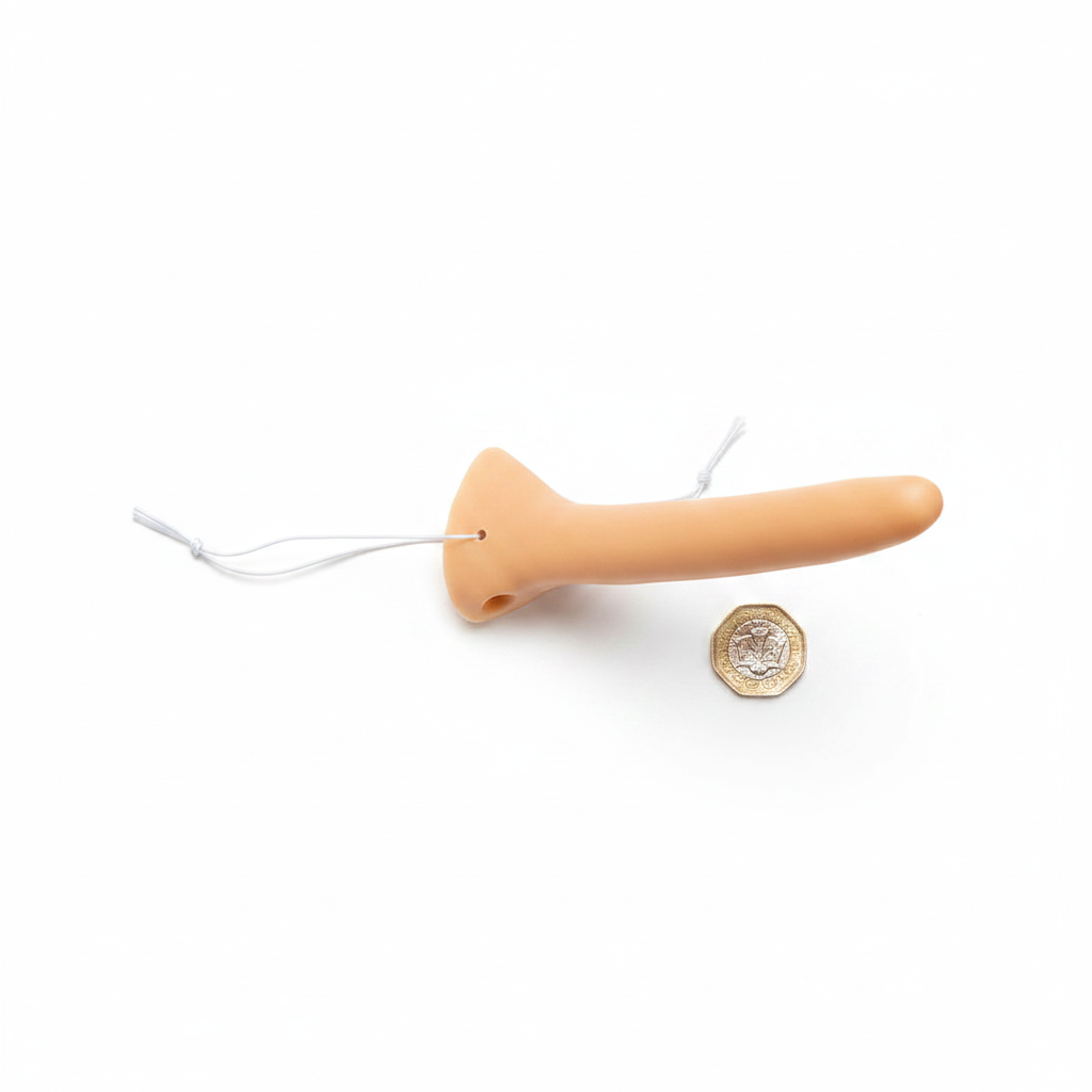 Long Nose Liar Pinocchio mask beside a £1 coin on white background showing product size — flat lay