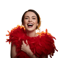 A woman with dark hair pulled back, wearing a bright red feather boa around her shoulders, set against a solid white background.