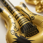 Extreme macro close-up of gold metallic inflatable guitar body showing glossy PVC texture and Rock n Roll starburst graphics