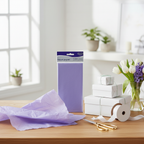 Lilac tissue paper pack styled on a gift wrapping station with ribbon, scissors and spring flowers