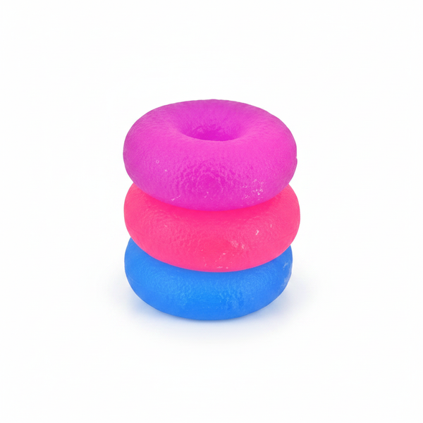 Squidgy Donut In Box squishy foam donut toys in hot pink, bubblegum pink and sky blue on white studio background