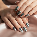 Close-up of reflective metallic chrome nails with Technic Asteroid pigment on rose gold silk fabric