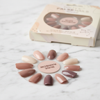 Technic Almond 24 False Nails in Nude Rainbow gradient with glue on marble surface