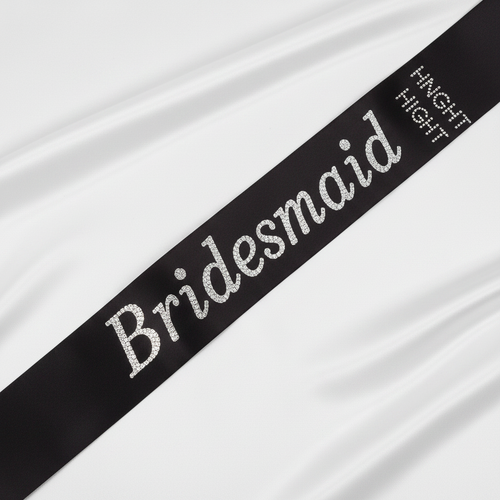 Black satin and diamante bridesmaid sash displayed on white background showing luxurious satin finish and sparkling crystal detailing