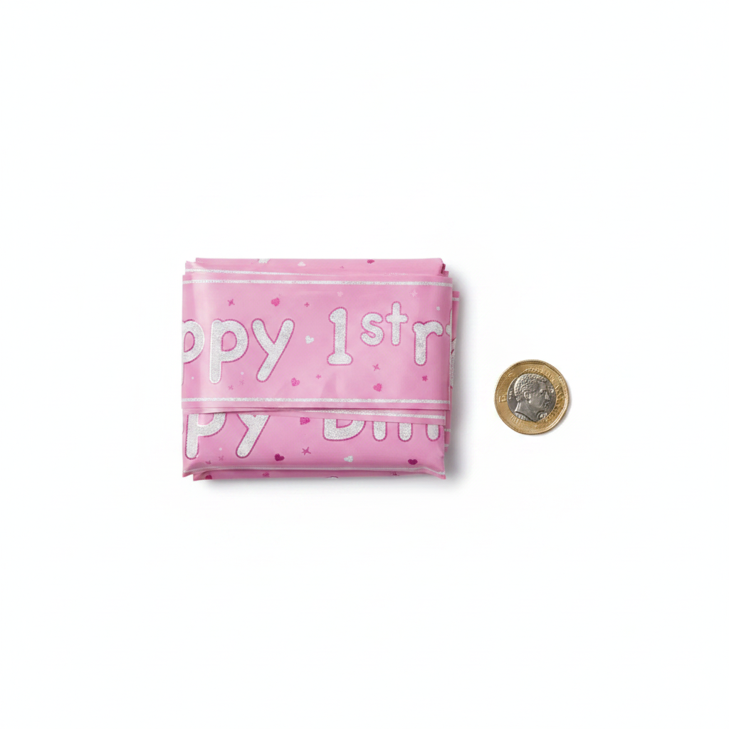 Pink Glitz 1st Birthday Banner flat lay with £1 coin for size reference showing 2.7m length