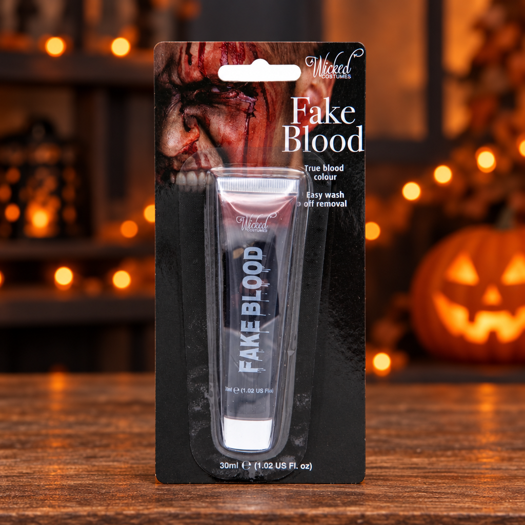 Wicked Costumes fake blood 30ml pack on a Halloween display with lights and pumpkin