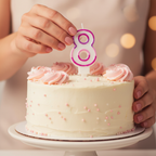 Hands placing Pink Number 8 Birthday Candle onto a decorated birthday cake