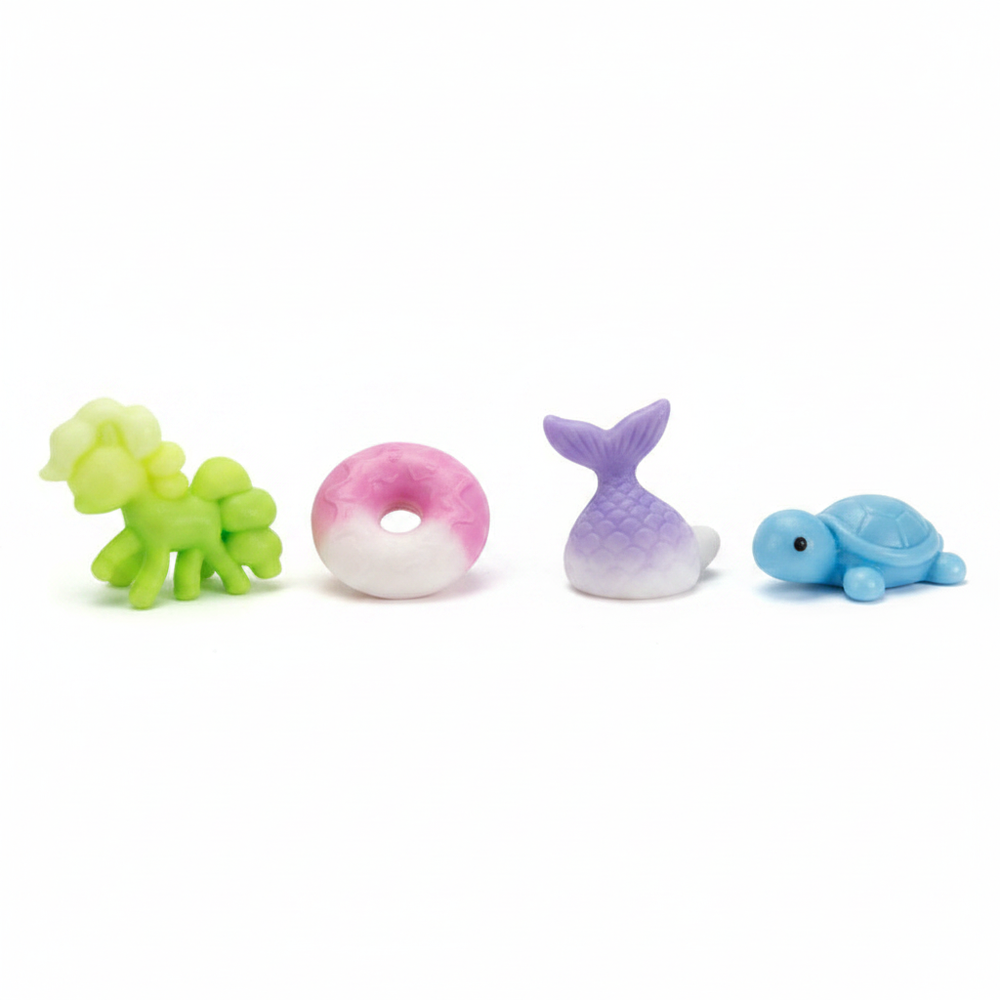 Four assorted squishy squeeze toys in lime green, pink, lavender and sky blue on pure white background