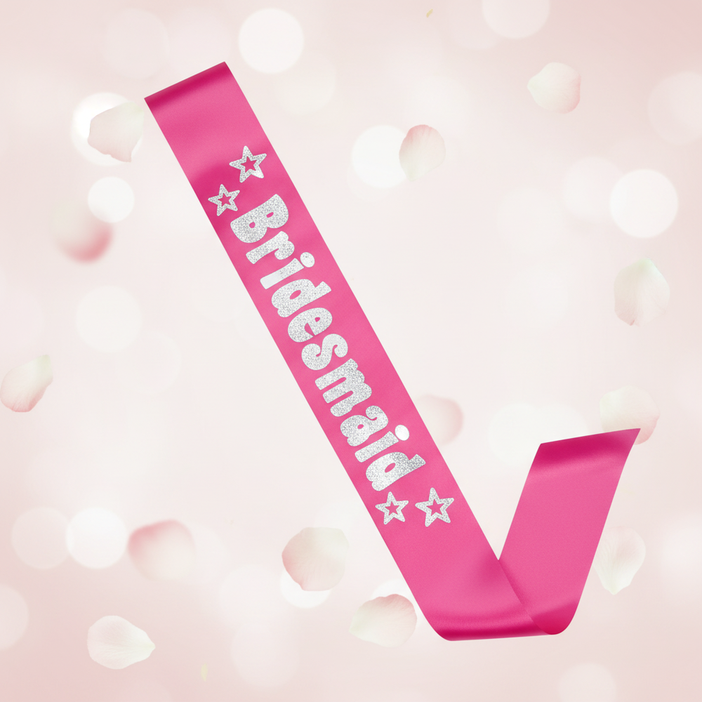 Hot Pink Bridesmaid Sash with Silver Foil Writing displayed against a soft blush and ivory background – elegant bridal accessory