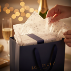 White tissue paper with silver stars arranged in a luxury gift bag for a celebration