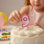Hands placing Pink Number 9 Birthday Candle onto a birthday cake