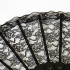Close-up macro detail of intricate floral black lace pattern on hand fan