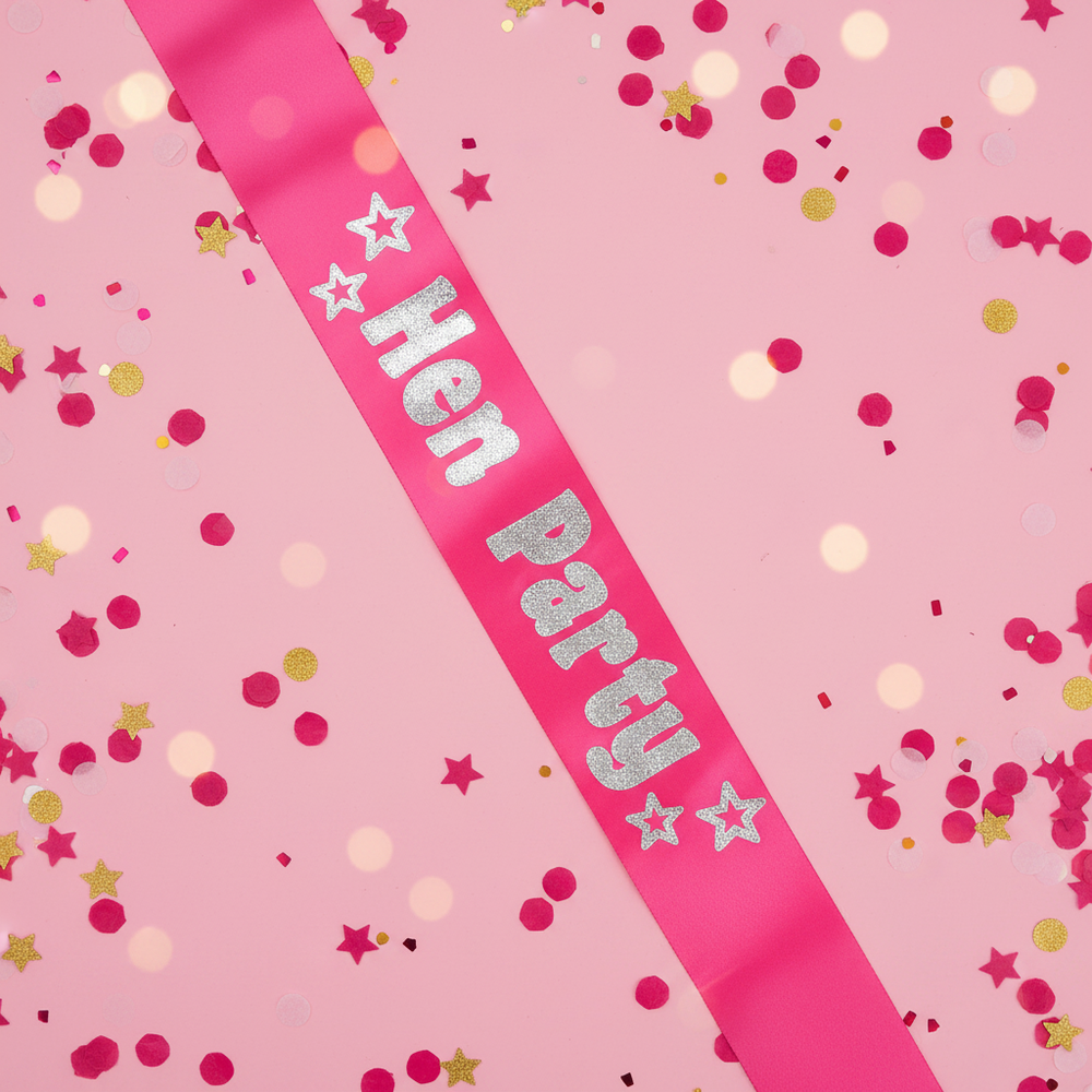 Hot Pink and Silver Foil Hen Party Sash displayed against a vibrant pink and gold confetti background – fun party accessory