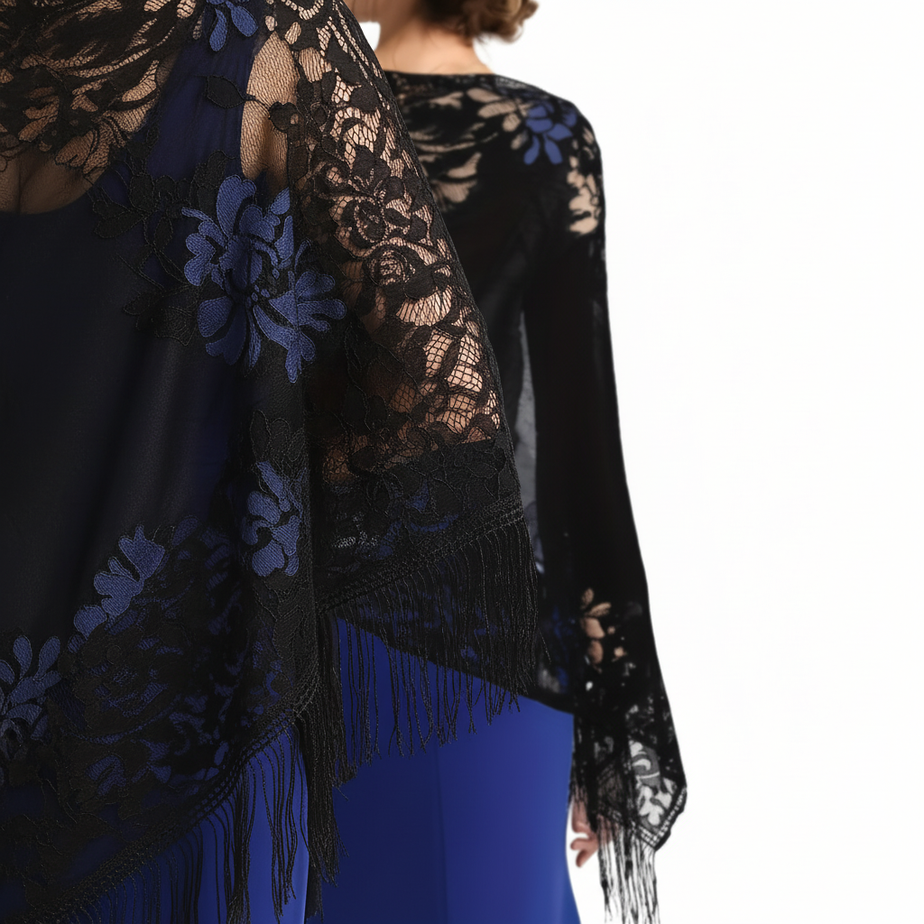 Close-up detail of black lace floral pattern and tassel fringe on evening pashmina shawl