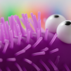 Extreme macro close-up of the purple puffer spines and rubber texture of the Big Eye Puffer Caterpillar squeeze toy