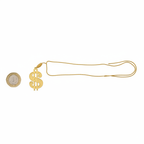 Flat lay of gold dollar medallion necklace beside a £1 coin showing scale, with chain fully extended on white background