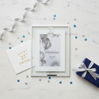 Milestones Silver Age 21 Photo Frame flat lay with birthday accessories on marble surface